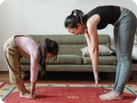 Mother and daughter exercising and stretching together